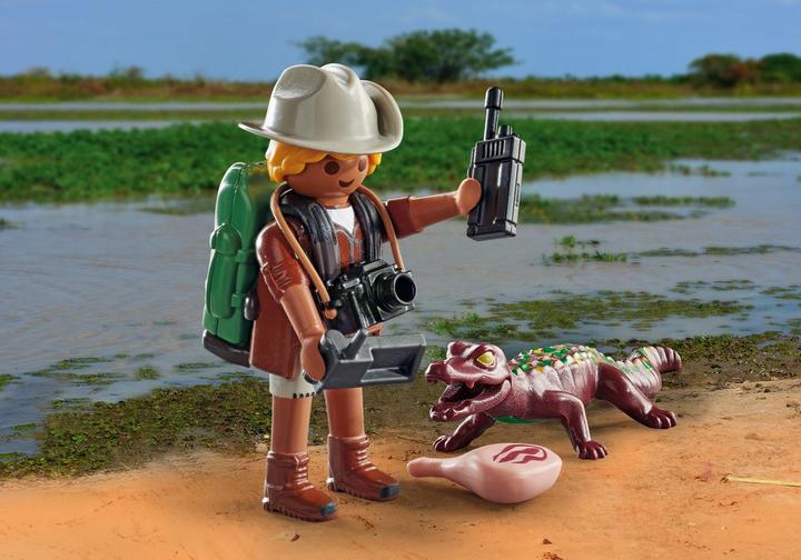 Researcher with young caiman